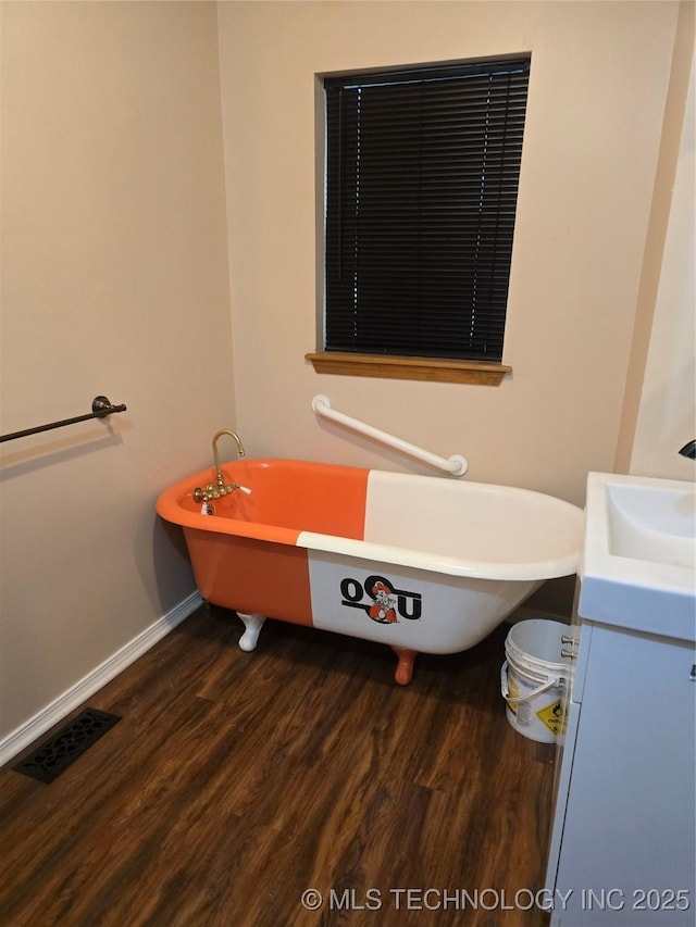 617 N 11th St, Pawnee, OK 74058 - bathroom with wood finished floors, vanity, and a soaking tub