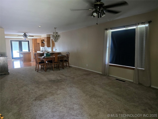 617 N 11th St, Pawnee, OK 74058 - carpeted dining area with a ceiling fan and a chandelier