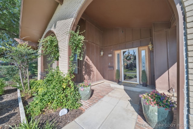 7058 E 52nd Pl, Tulsa, OK 74145 - doorway to property with brick siding and board and batten siding