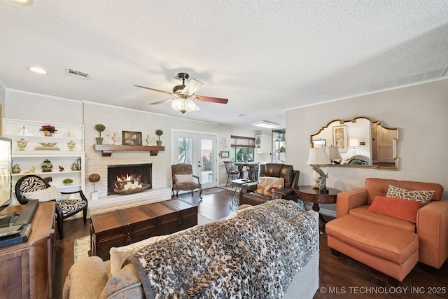 7058 E 52nd Pl, Tulsa, OK 74145 - living area with a textured ceiling, wood finished floors, a brick fireplace, ceiling fan, and ornamental molding