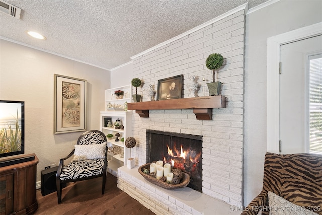 7058 E 52nd Pl, Tulsa, OK 74145 - living room with a textured ceiling, wood finished floors, ornamental molding, a fireplace, and healthy amount of natural light