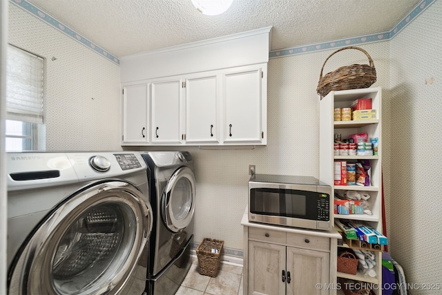 7058 E 52nd Pl, Tulsa, OK 74145 - laundry room with washing machine and dryer, cabinet space, wallpapered walls, a textured ceiling, and tile patterned flooring