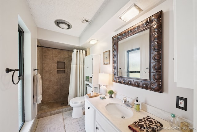7058 E 52nd Pl, Tulsa, OK 74145 - bathroom with vanity, a stall shower, a textured ceiling, and tile patterned floors