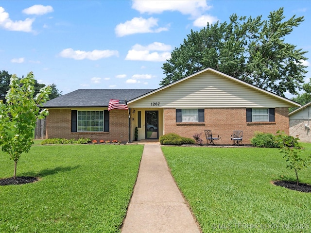 1267 Guinn Ln, Bartlesville, OK 74006 - ranch-style home featuring a front yard, brick siding, and roof with shingles