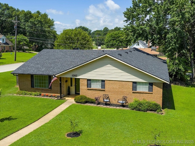 1267 Guinn Ln, Bartlesville, OK 74006 - single story home with brick siding, a shingled roof, and a front yard