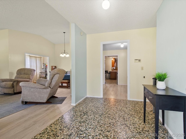 1267 Guinn Ln, Bartlesville, OK 74006 - hallway with a chandelier, wood finished floors, a textured ceiling, and lofted ceiling