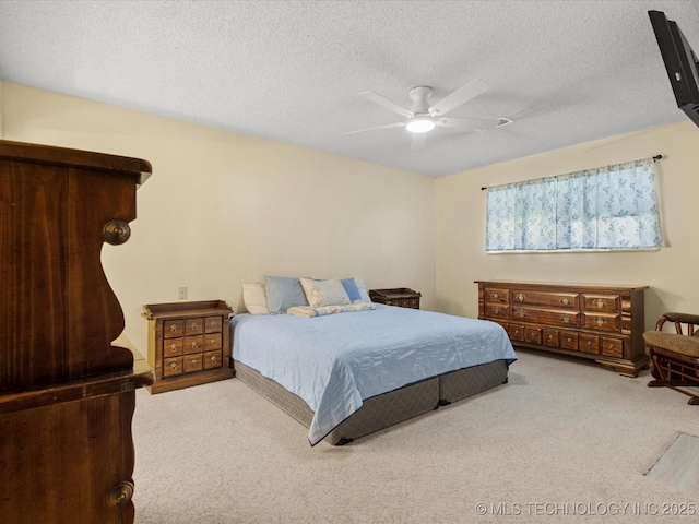 1267 Guinn Ln, Bartlesville, OK 74006 - carpeted bedroom with a textured ceiling and a ceiling fan