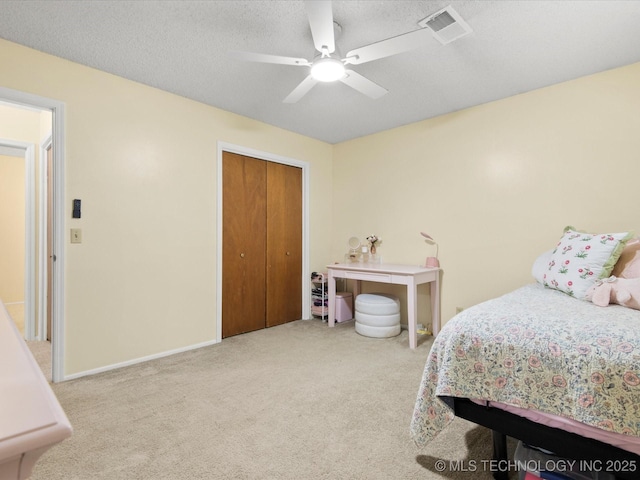 1267 Guinn Ln, Bartlesville, OK 74006 - carpeted bedroom with a closet, a ceiling fan, and a textured ceiling