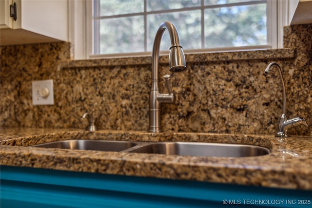 3609 E Scenic Dr, Cushing, OK 74023 - kitchen view of tasteful backsplash, white cabinets, and dark stone countertops