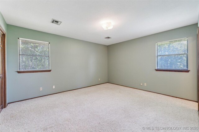 3609 E Scenic Dr, Cushing, OK 74023 - carpeted empty room with healthy amount of natural light