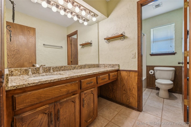 3609 E Scenic Dr, Cushing, OK 74023 - full bathroom with vanity, bathtub / shower combination, wainscoting, and tile patterned flooring