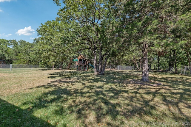 3609 E Scenic Dr, Cushing, OK 74023 - fenced backyard featuring a playground