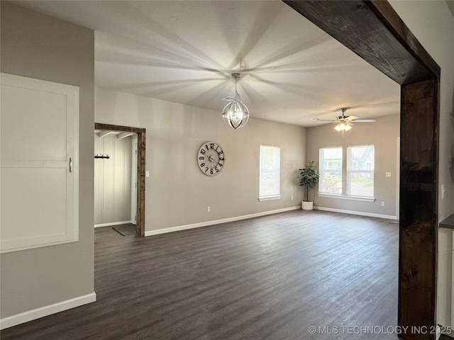 911 E Maple St, Cushing, OK 74023 - spare room featuring dark wood-style flooring and a ceiling fan