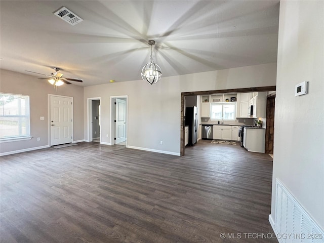 911 E Maple St, Cushing, OK 74023 - unfurnished living room with dark wood-style floors and ceiling fan