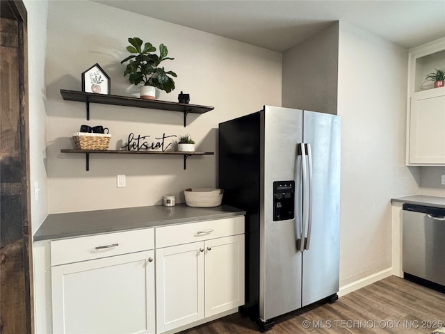 911 E Maple St, Cushing, OK 74023 - kitchen featuring stainless steel appliances, open shelves, dark wood-type flooring, white cabinets, and dark countertops