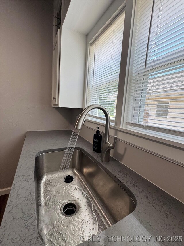 911 E Maple St, Cushing, OK 74023 - kitchen view of a sink and white cabinetry