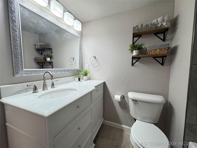 911 E Maple St, Cushing, OK 74023 - bathroom featuring vanity and wood finished floors