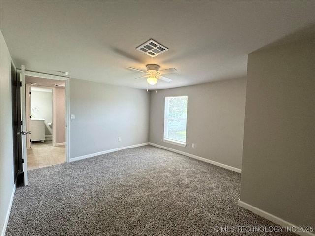 911 E Maple St, Cushing, OK 74023 - carpeted empty room featuring baseboards and a ceiling fan