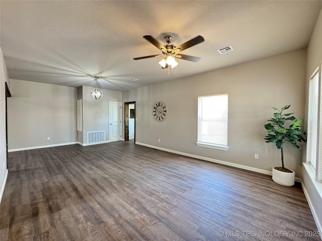 911 E Maple St, Cushing, OK 74023 - unfurnished living room with dark wood-type flooring and ceiling fan