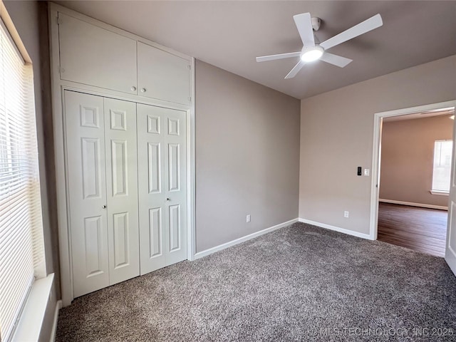 911 E Maple St, Cushing, OK 74023 - unfurnished bedroom with dark colored carpet, a closet, and ceiling fan