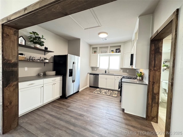 911 E Maple St, Cushing, OK 74023 - kitchen featuring appliances with stainless steel finishes, open shelves, dark wood-style flooring, and white cabinets
