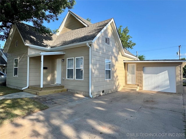 911 E Maple St, Cushing, OK 74023 - view of front of house with a garage, roof with shingles, concrete driveway, an outbuilding, and crawl space