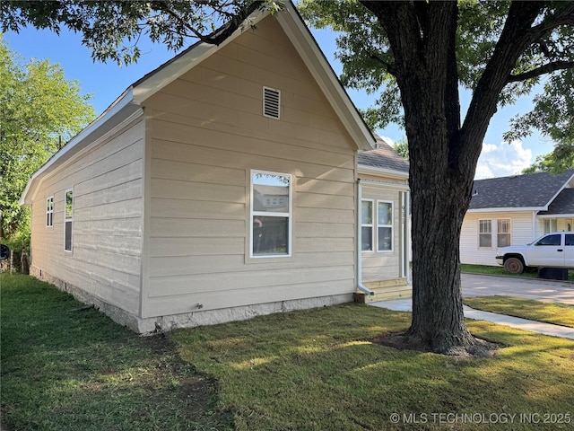 911 E Maple St, Cushing, OK 74023 - view of home's exterior with a lawn