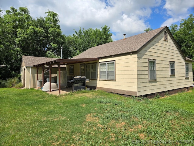 615 11th St, Pawnee, OK 74058 - back of house with roof with shingles, a lawn, and a patio area