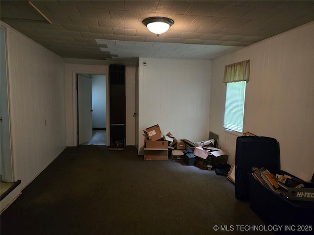 615 11th St, Pawnee, OK 74058 - misc room with carpet and wooden walls
