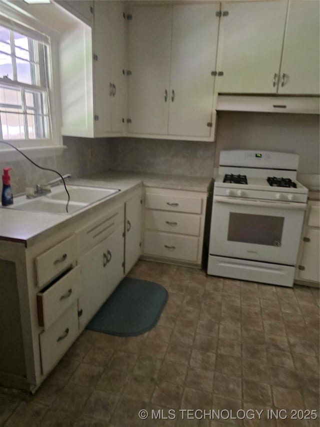 615 11th St, Pawnee, OK 74058 - kitchen with gas range gas stove, white cabinets, and ventilation hood