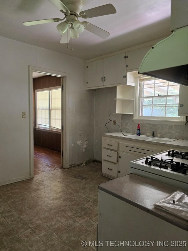 615 11th St, Pawnee, OK 74058 - kitchen featuring extractor fan, white cabinetry, and a ceiling fan