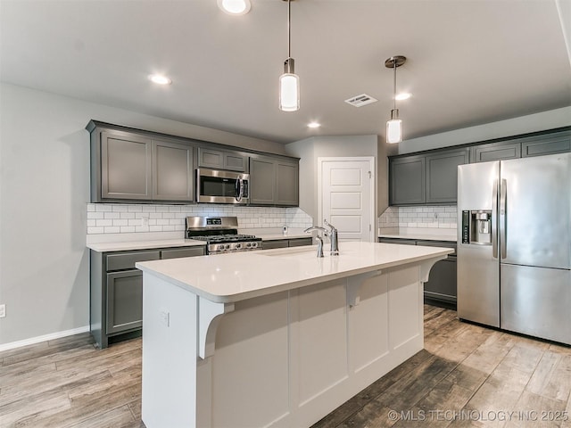 3604 E Quebec St, Broken Arrow, OK 74014 - kitchen featuring appliances with stainless steel finishes, light wood finished floors, light countertops, backsplash, and recessed lighting