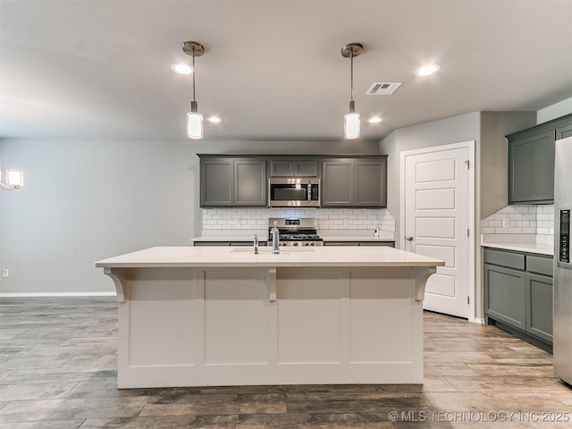 3604 E Quebec St, Broken Arrow, OK 74014 - kitchen with appliances with stainless steel finishes, light countertops, backsplash, pendant lighting, and recessed lighting