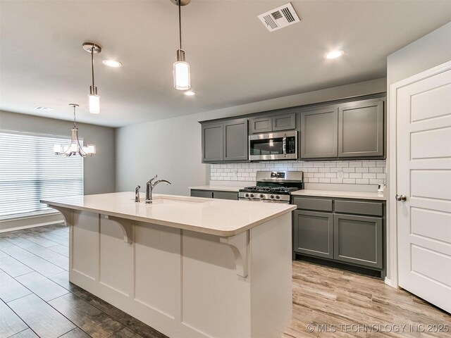 3604 E Quebec St, Broken Arrow, OK 74014 - kitchen with appliances with stainless steel finishes, gray cabinetry, light wood-style floors, and recessed lighting