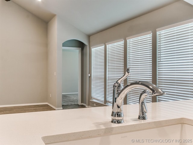 3604 E Quebec St, Broken Arrow, OK 74014 - kitchen view of arched walkways, wood finished floors, and light stone countertops