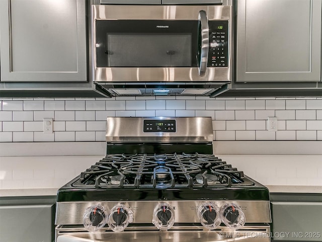 3604 E Quebec St, Broken Arrow, OK 74014 - kitchen view of appliances with stainless steel finishes, gray cabinetry, and tasteful backsplash