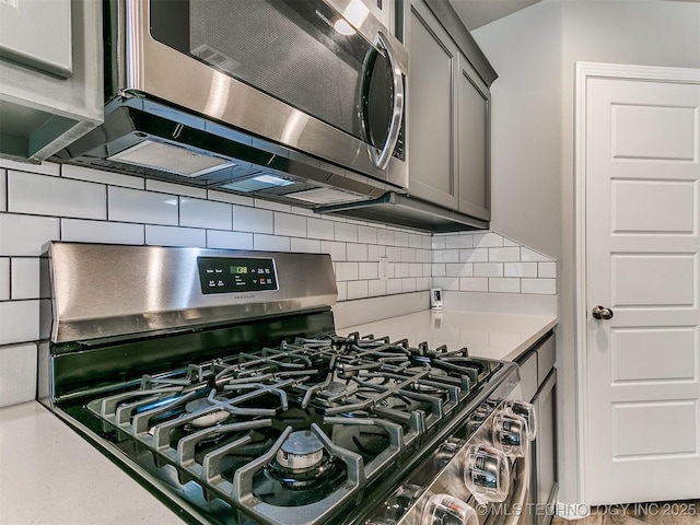 3604 E Quebec St, Broken Arrow, OK 74014 - kitchen view of appliances with stainless steel finishes, decorative backsplash, light countertops, and gray cabinetry