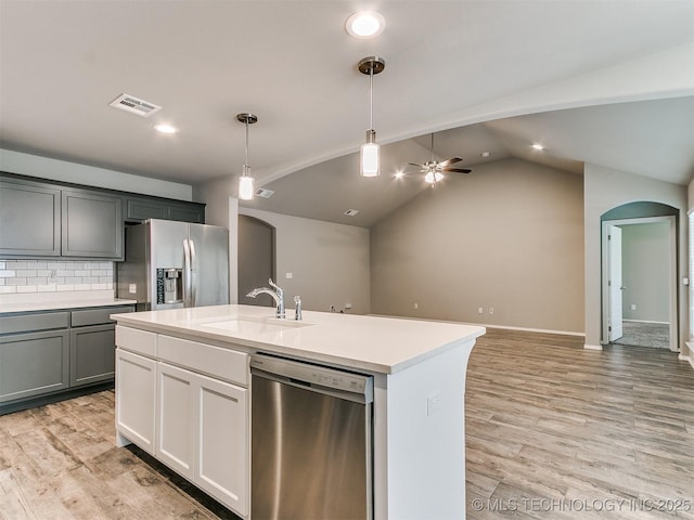 3604 E Quebec St, Broken Arrow, OK 74014 - kitchen featuring stainless steel appliances, arched walkways, light countertops, light wood-type flooring, and recessed lighting