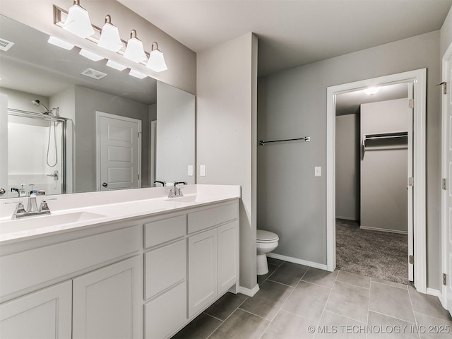 3604 E Quebec St, Broken Arrow, OK 74014 - bathroom with double vanity, a shower with door, tile patterned floors, and a spacious closet