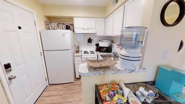 6663 S Victor Ave Unit Hj303, Tulsa, OK 74136 - kitchen featuring white appliances, extractor fan, white cabinets, light wood-type flooring, and decorative backsplash