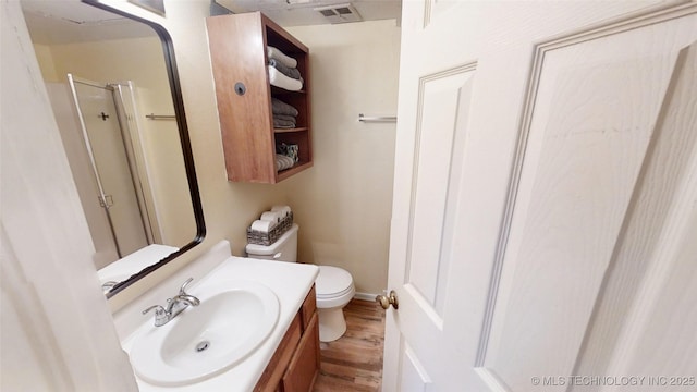 6663 S Victor Ave Unit Hj303, Tulsa, OK 74136 - bathroom featuring wood finished floors, vanity, and a shower with door