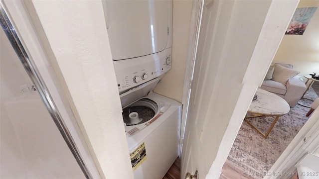 6663 S Victor Ave Unit Hj303, Tulsa, OK 74136 - laundry area with stacked washer and clothes dryer and wood finished floors