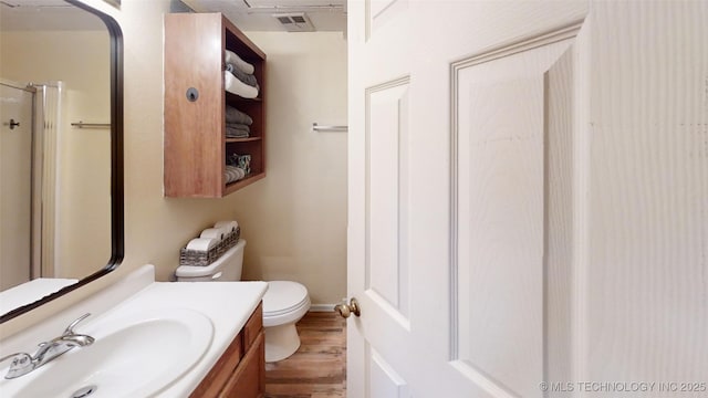 6663 S Victor Ave Unit Hj303, Tulsa, OK 74136 - full bath featuring wood finished floors, vanity, and a shower