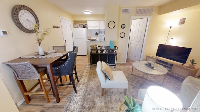 6663 S Victor Ave Unit Hj303, Tulsa, OK 74136 - living area featuring light wood-style floors and baseboards