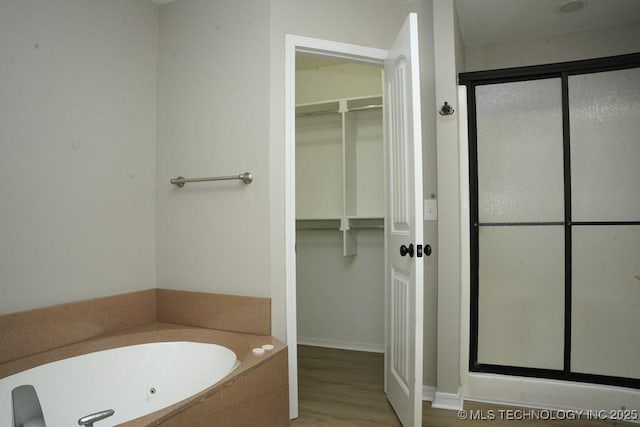 11906 S Nandina St, Jenks, OK 74037 - full bathroom with a shower stall, a jetted tub, wood finished floors, and a spacious closet