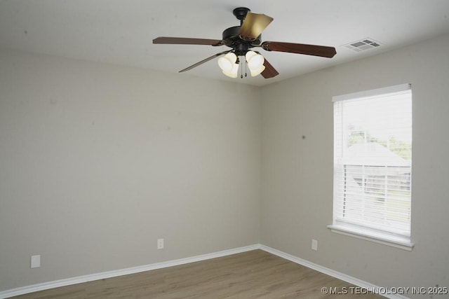 11906 S Nandina St, Jenks, OK 74037 - empty room with healthy amount of natural light, wood finished floors, and a ceiling fan