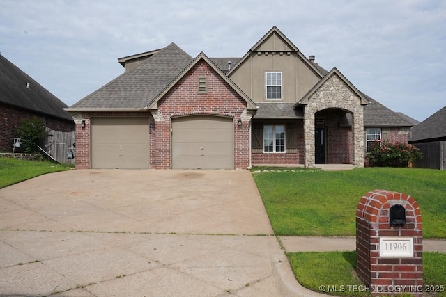 11906 S Nandina St, Jenks, OK 74037 - view of front of home with driveway, a front lawn, brick siding, a garage, and roof with shingles