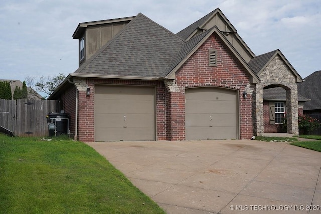 11906 S Nandina St, Jenks, OK 74037 - view of front facade with brick siding, concrete driveway, a garage, and a shingled roof
