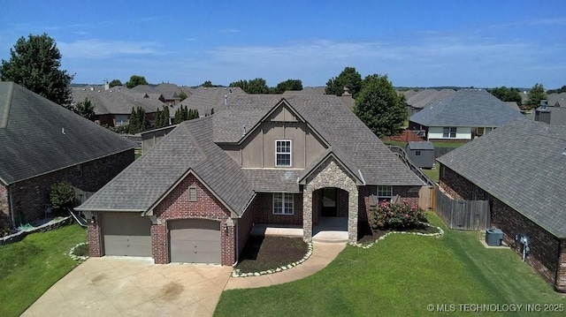 11906 S Nandina St, Jenks, OK 74037 - view of front of house featuring driveway, brick siding, a shingled roof, and a garage