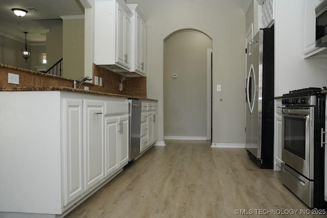 11906 S Nandina St, Jenks, OK 74037 - kitchen with appliances with stainless steel finishes, arched walkways, white cabinets, light wood-style flooring, and crown molding